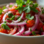 Close-up of a bowl of vibrant Cebolla Ensalada.